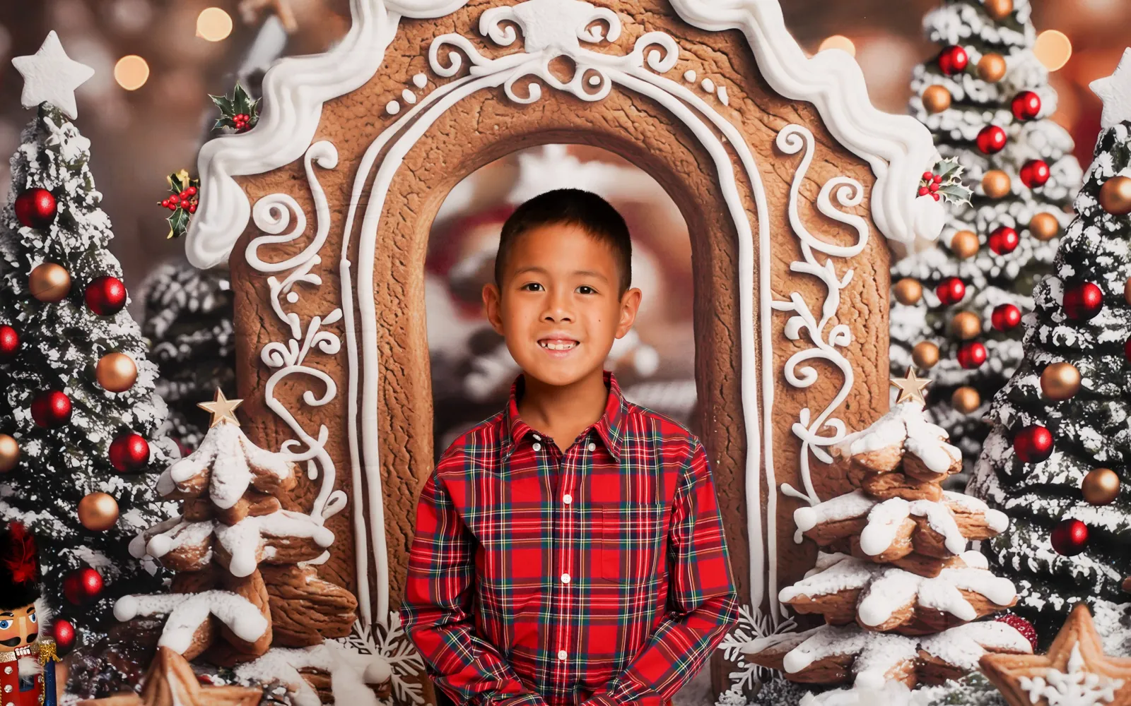 A boy in red plaid standing inside the gingerbread archway on Gingerbread Lane